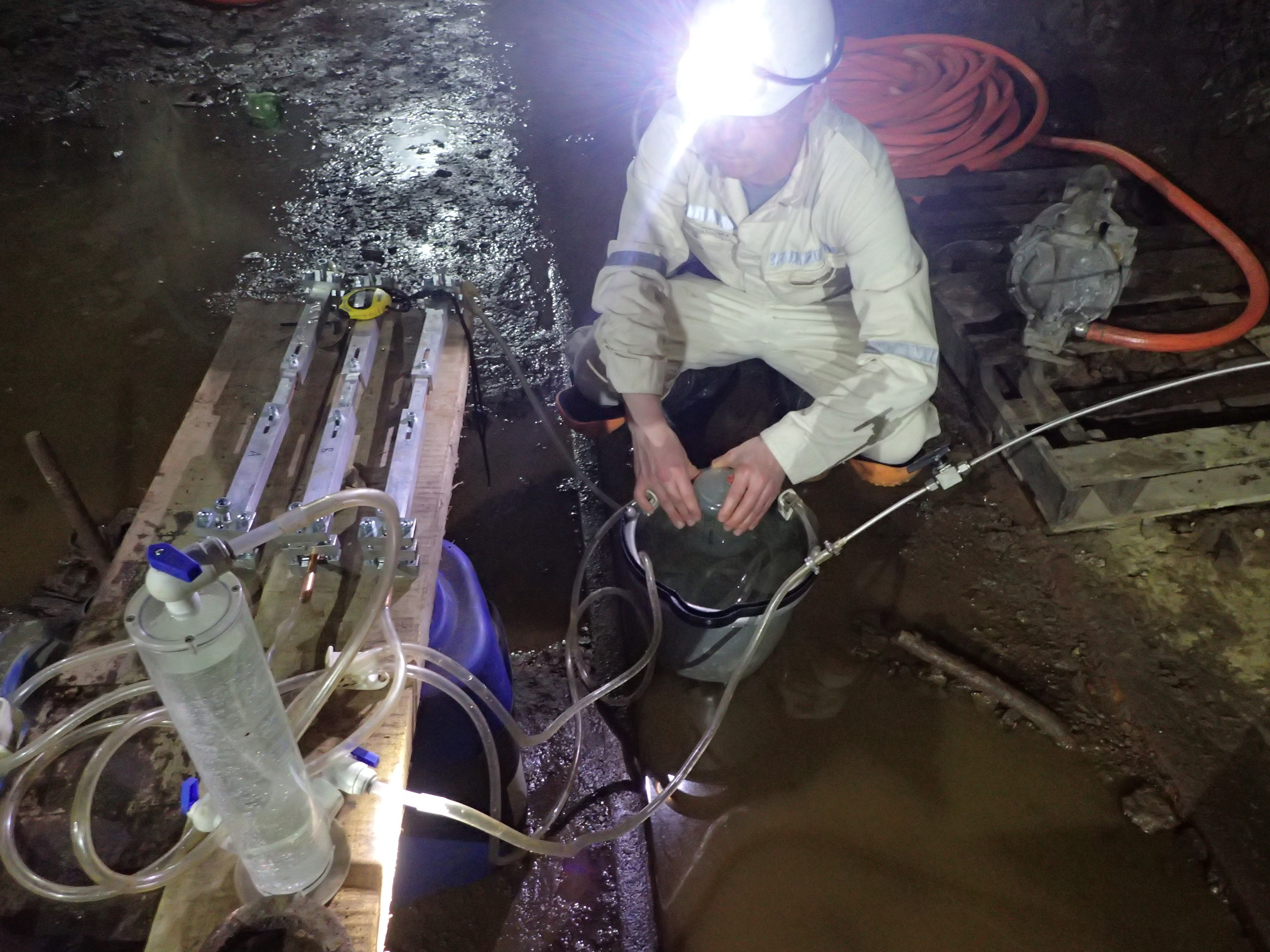  Oliver Warr standing deep inside a mine collecting water samples