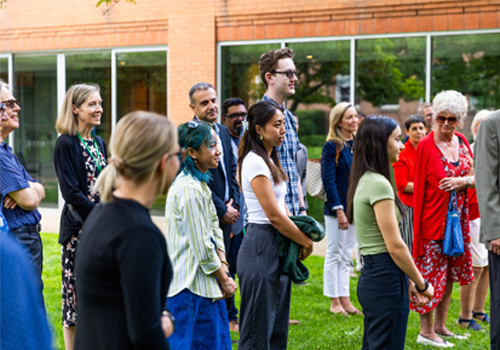 A group of people standing outside.