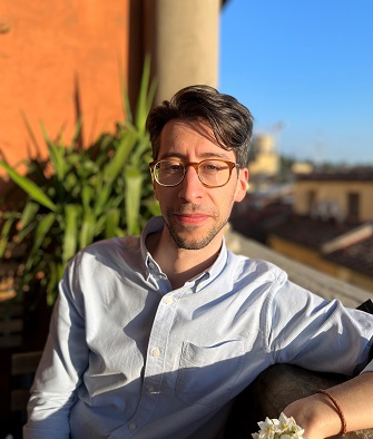 Daniele Iannuci sitting on a balcony on a bright summer day