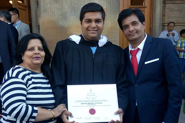 Dhyey Sejpal in a graduation gown, holding a diploma, with his parents Dipti Sejpal and Mayur Sejpal at Convocation Hall.