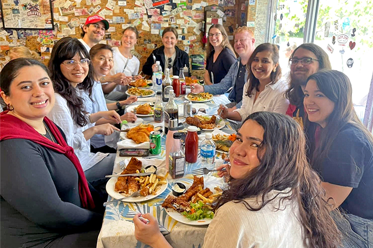 A group of people sitting around a dining table.