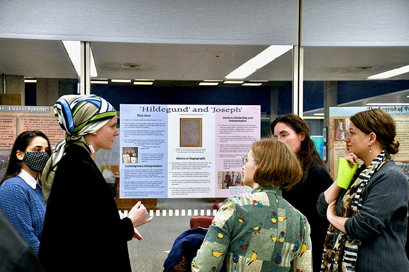Students looking a research poster