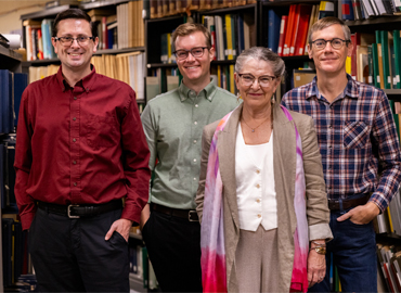 Standing in a group, Co-editor Stephen Pelle, Postdoctoral Fellow Cameron Laird, Managing Editor Catherine Monahan and Co-editor Robert Getz.