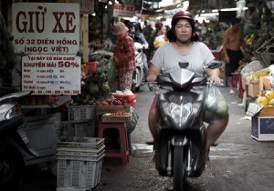 Woman on a scooter in a market