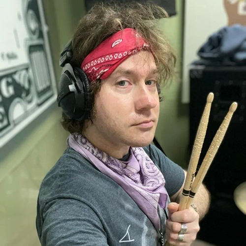 Martin Arno holding drumsticks.
