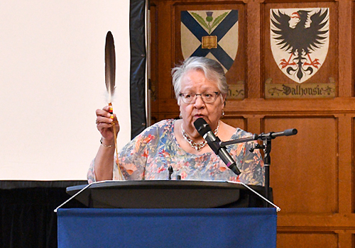 Eileen Antone displays a special eagle feather that emphasizes building relationships.  
