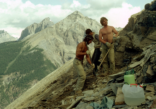 Three men conducting field work on Mount Stephen