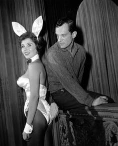 Playboy magazine publisher Hugh Hefner poses with Playboy Bunny hostess Bonnie J. Halpin 