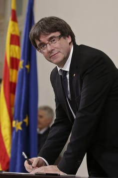 Catalan regional President Carles Puigdemont signs an independence declaration