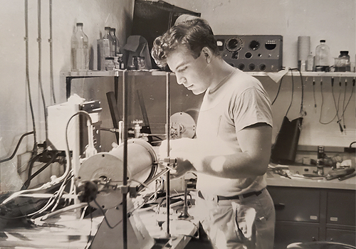 David Fraser inside of a lab. A black and white photo.