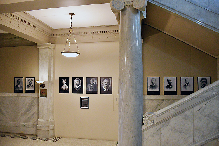 A wall of portraits displayed in the Lillian Massey Building.