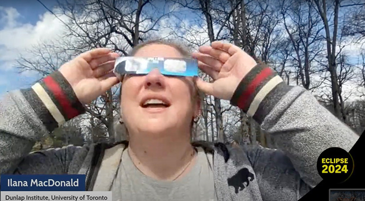 Ilana MacDonald wearing safety glasses to look at the eclipse.