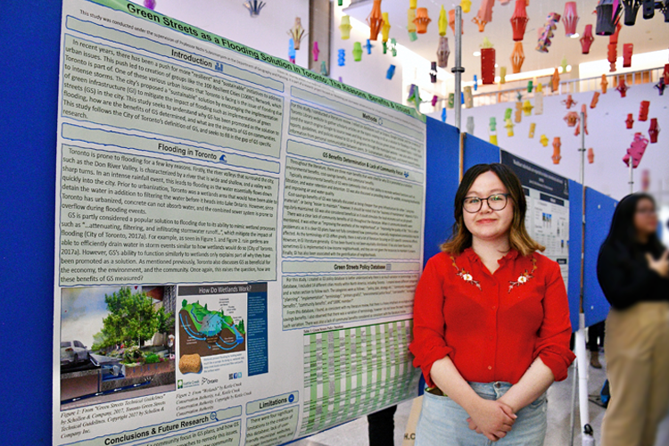 Eileen Murray standing in front of her poster