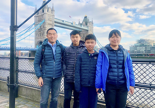 Greg Chen with family in front of Tower Bridge in London, UK.