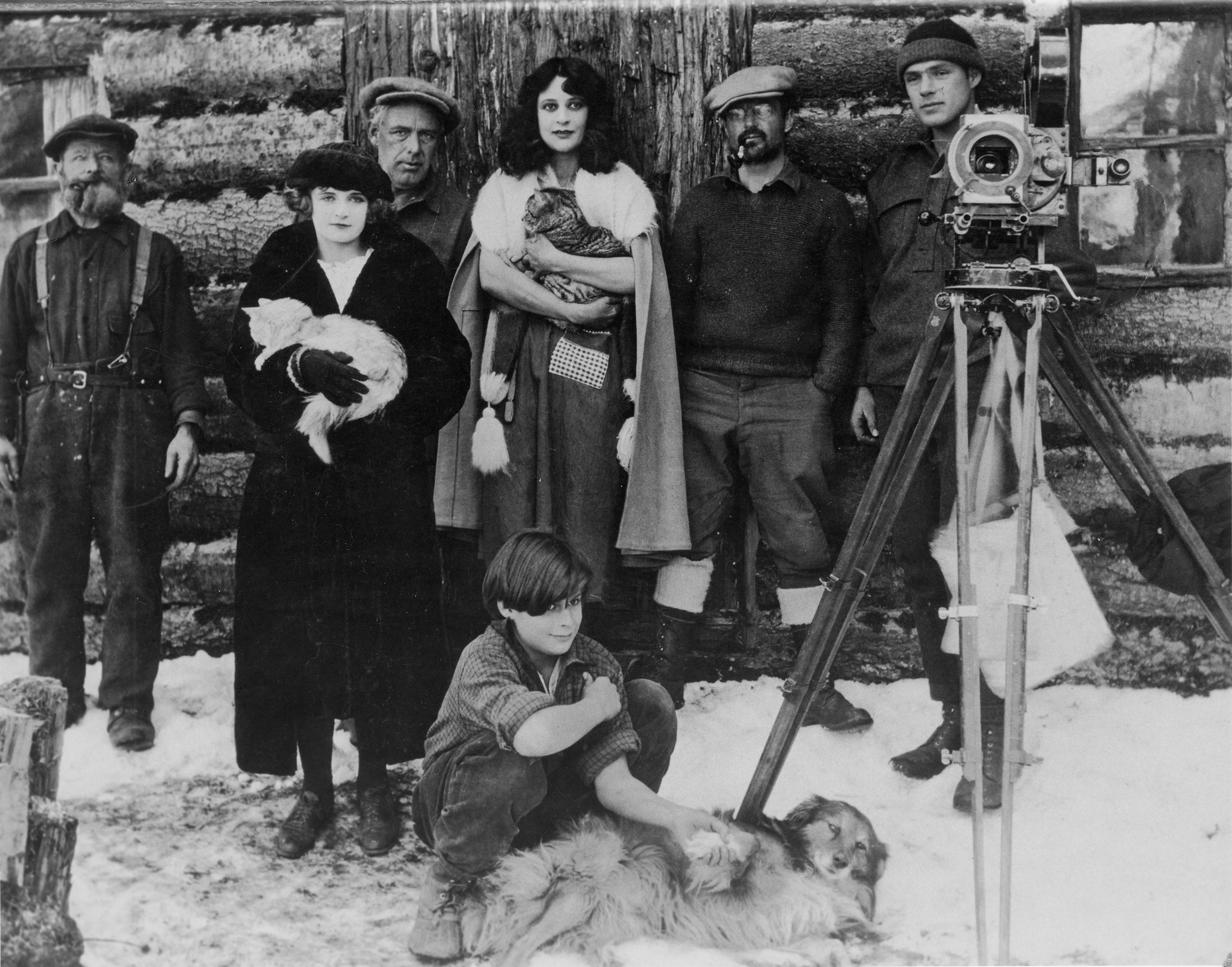 Nell Shipman and the cast of Trail of the North Wind in front of a cabin