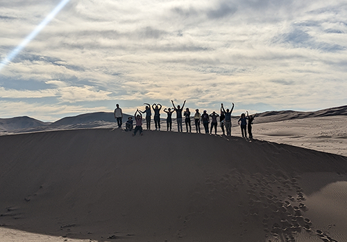 Instructors and students enjoying a break to have some fun on a sand dune in Chile's Atacama Desert