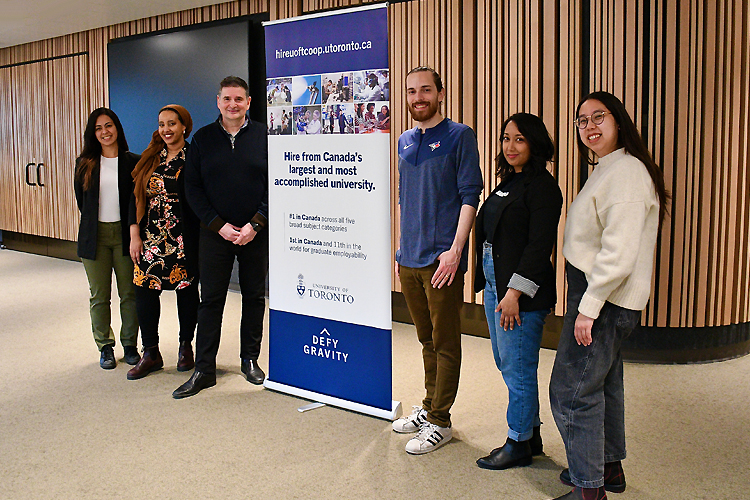Shabnam Abbarin, Timaj Garad, Giulio Fazzolari, Liam Stevenson, Cherise Seuchuran and Joyco To standing in front of a banner.