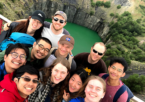 A group of students stand in front of the giant waterfilled Big Hole in Kimberley.