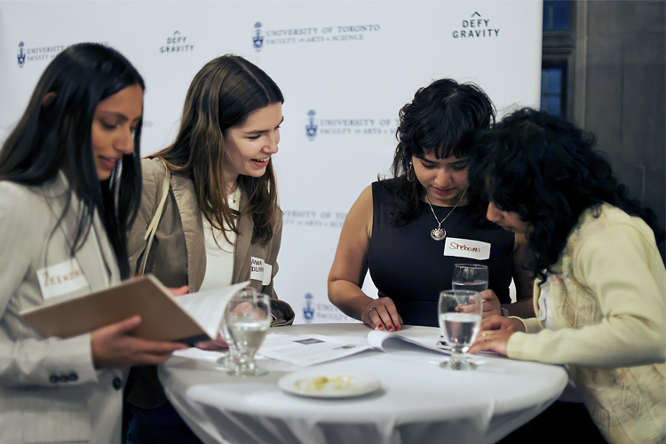 A group of people read around a table.
