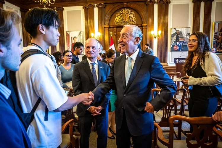 Portuguese President Marcelo Rebelo de Sousa shakes hands with a student  