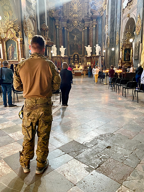 Ukrainian soldier praying in a church