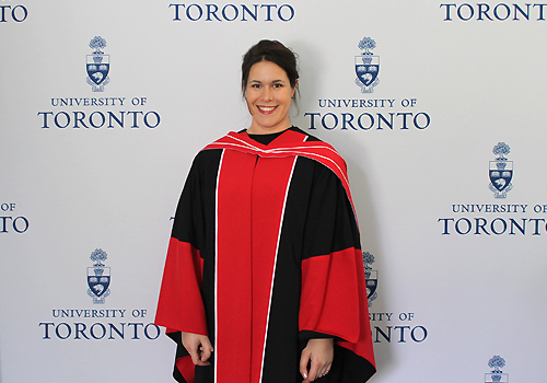 Christine Hone-Buske poses in front of U of T step and repeat.