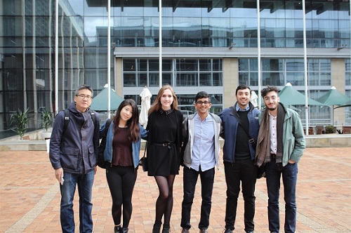 Professor Joseph Wong with five Munk students posing for a photo.