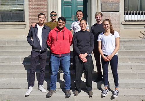 The iMerciv team standing in front of a building on a bright sunny day.