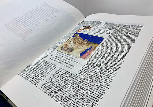 An open book with a blue and beige image of a dessert and people in the middle of the page.