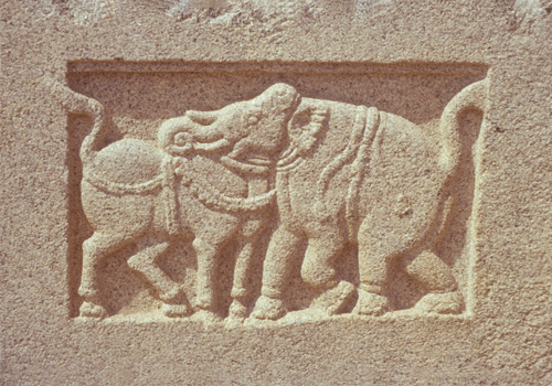 Stone with two carved elephants in the middle.