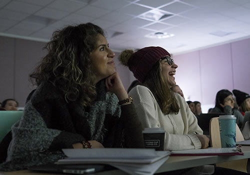 Students Isabella Eldeib and Maria Rocha Abello laughing in class.