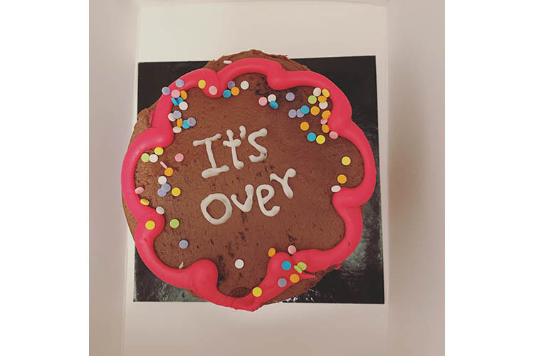 Cake that reads "It's over"