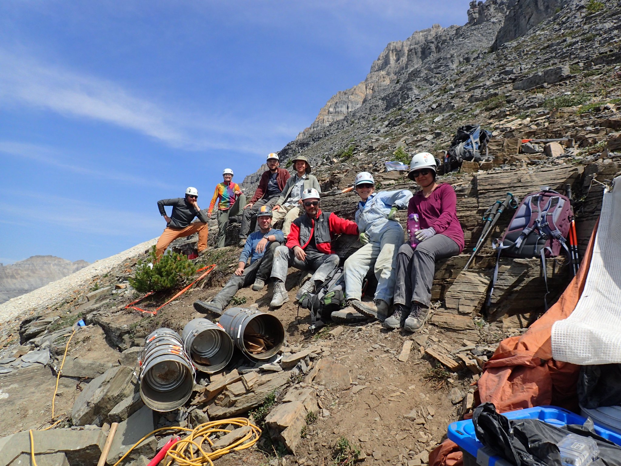 A group of seven people with equipment posing on a hill in the Burgess Shale