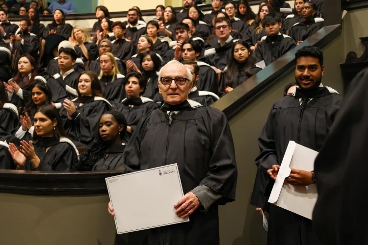 Jacques Leduc holding a U of T envelope.