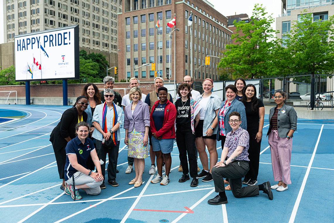 Several people posed for a photo on the Varsity Stadium track