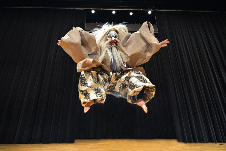 A costumed dancer leaping in the air