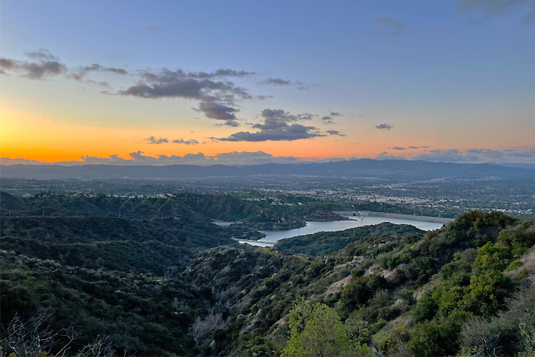 A beautiful sunset above a lush green landscape.