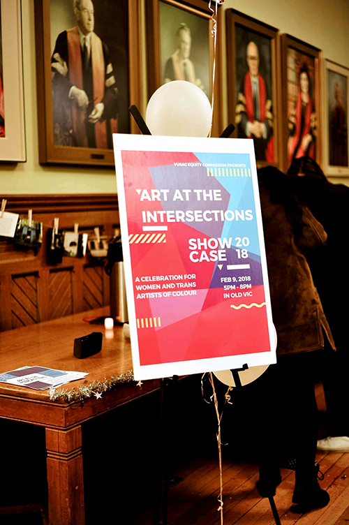 A pink and blue poster that says "Art at the Intersections."
