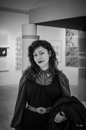 Maggie MacDonald standing in an art gallery
