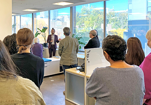 Uahikea Maile presenting information to a large group of people within the Innovation Lab.