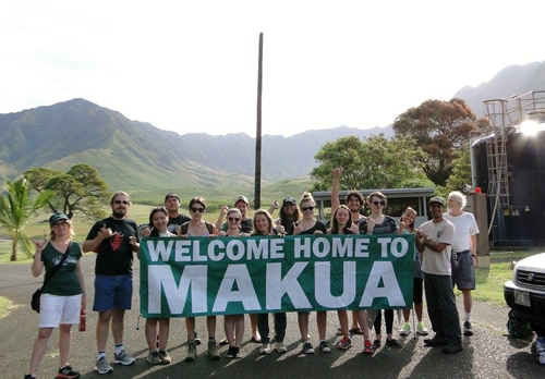 Group of students holding a sign that says "Welcome home to Mahua"