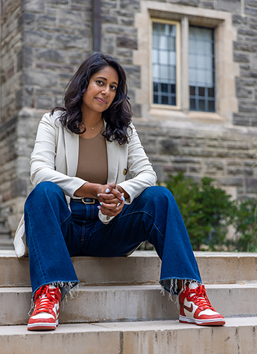 Azrah Manji-Savin sitting on steps.