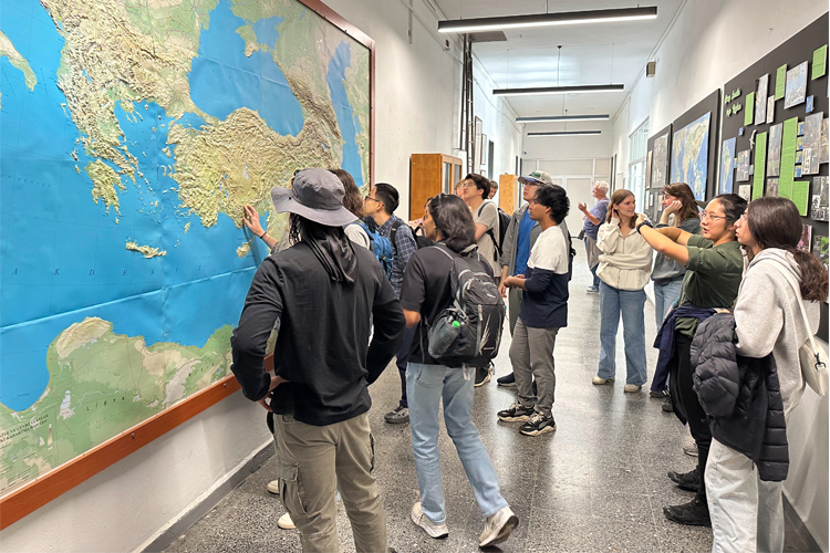 A group of students looking at a large map.