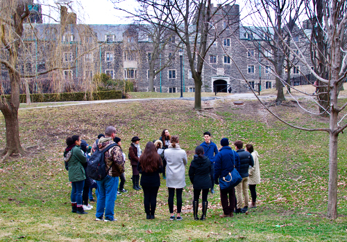 Andrea Most and students outdoors standing in a circle