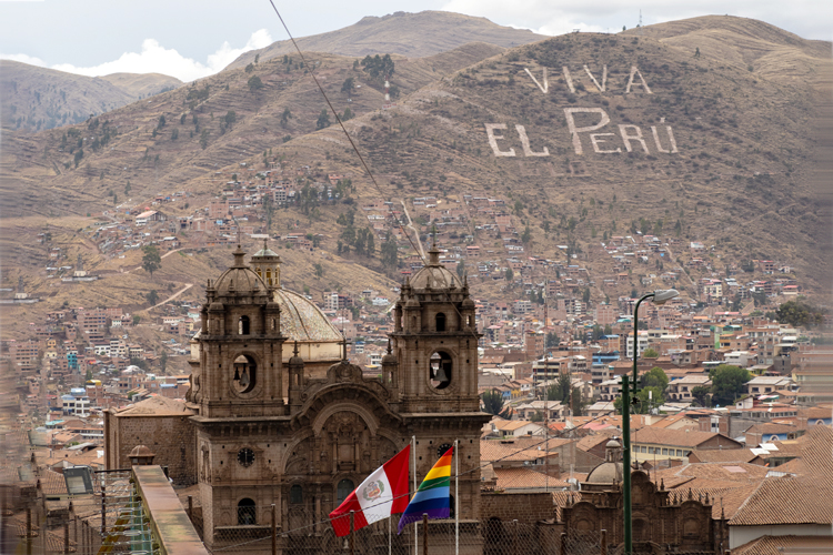 A mountain view, words built into the side of the mountain say, "Viva el Peru."