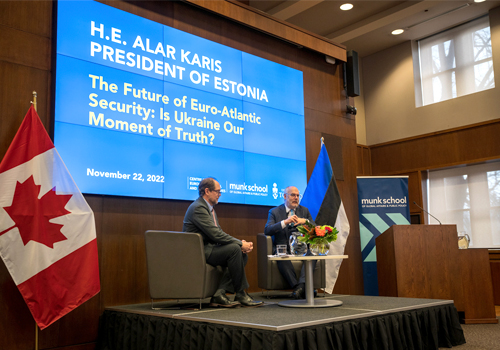 Estonian President Alar Karis on stage with Andres Kasekamp
