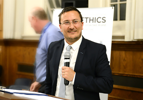 Paolo Granata  holding a mic speaking at an event