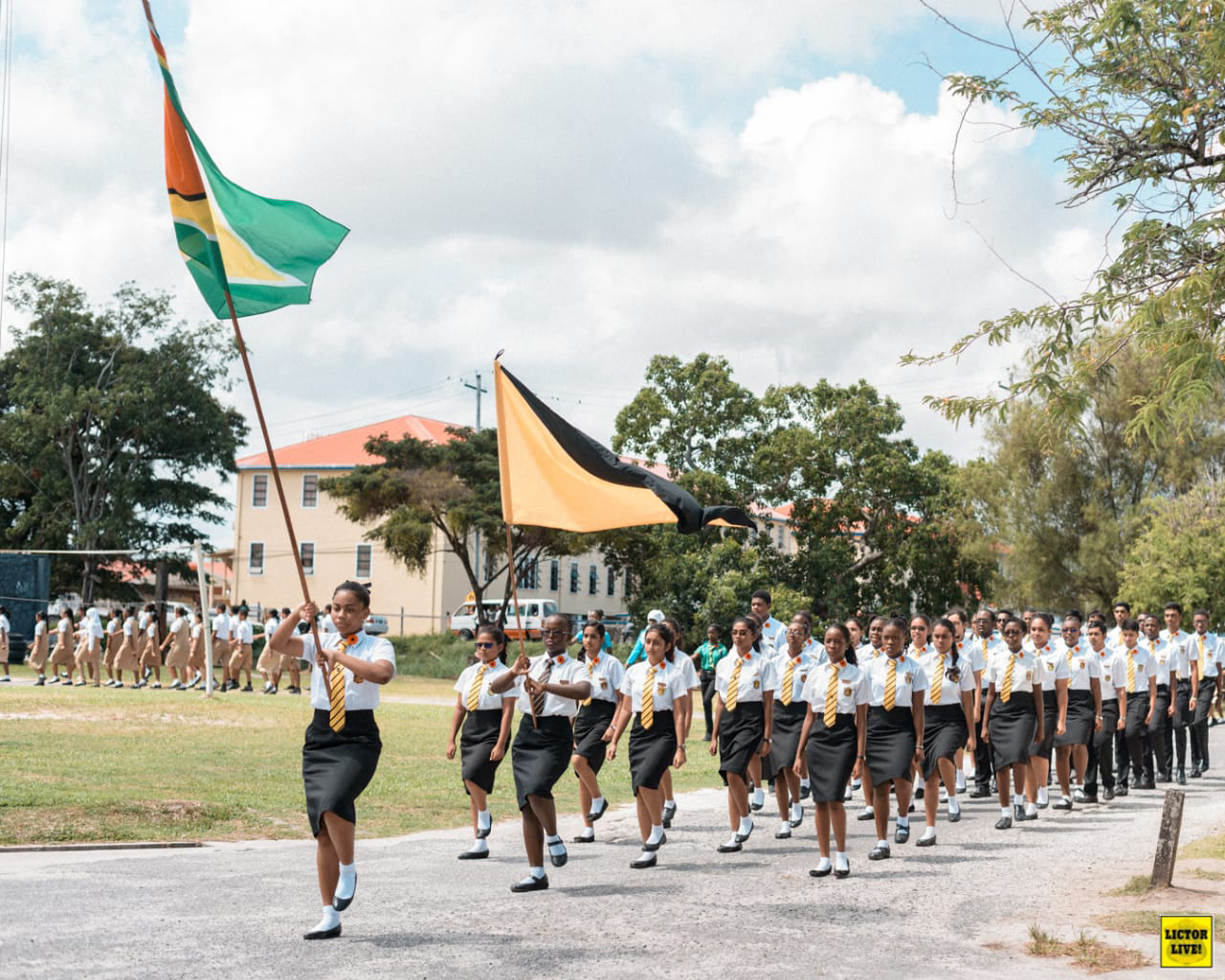  Alyssa Nurse (holding first flag) and her high school class in Guyana for a Remembrance Day Ceremony.