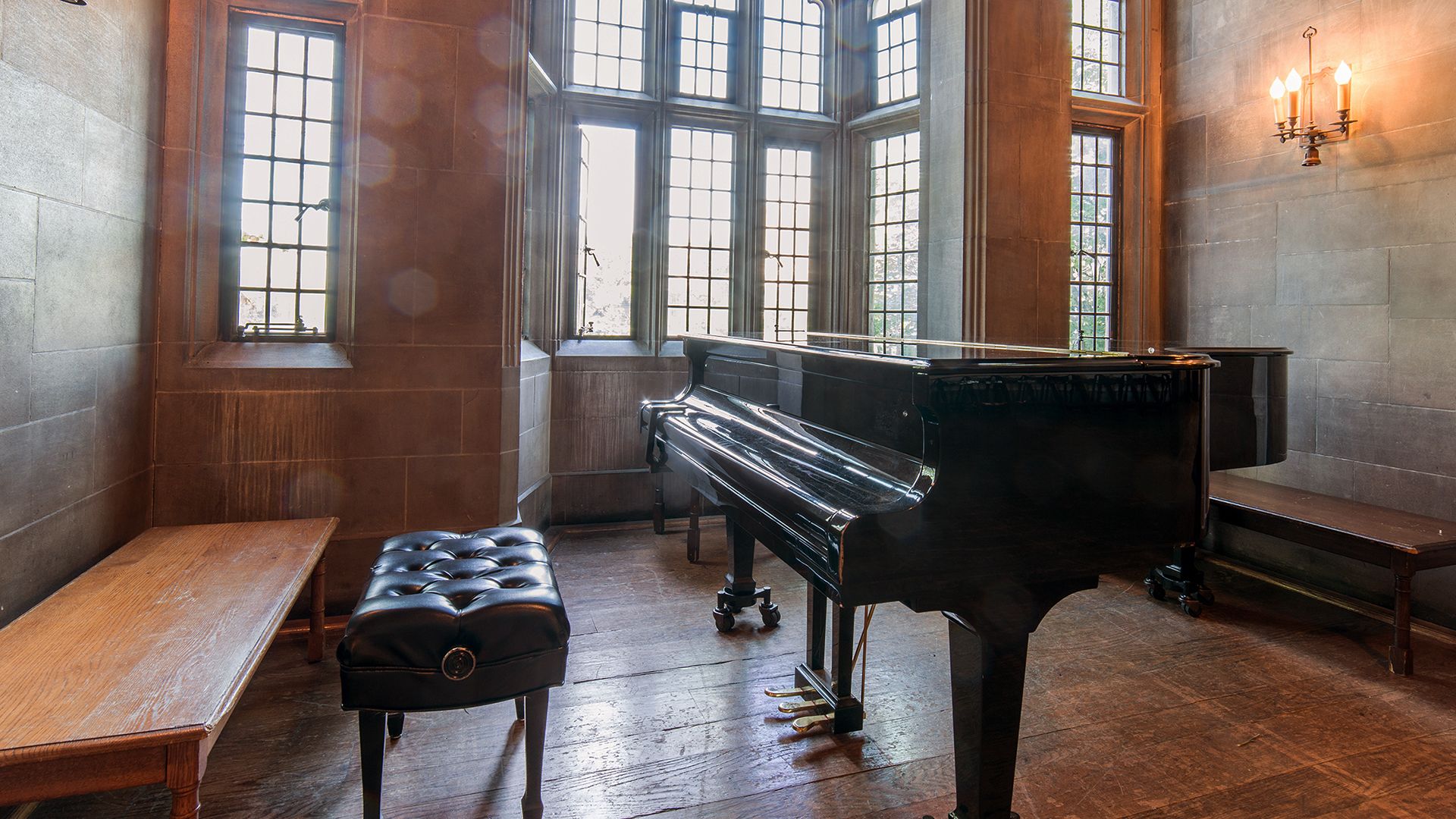 a grand piano in a sunlit room