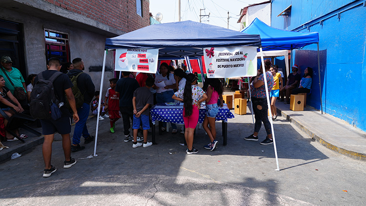 People standing at a table under a tent